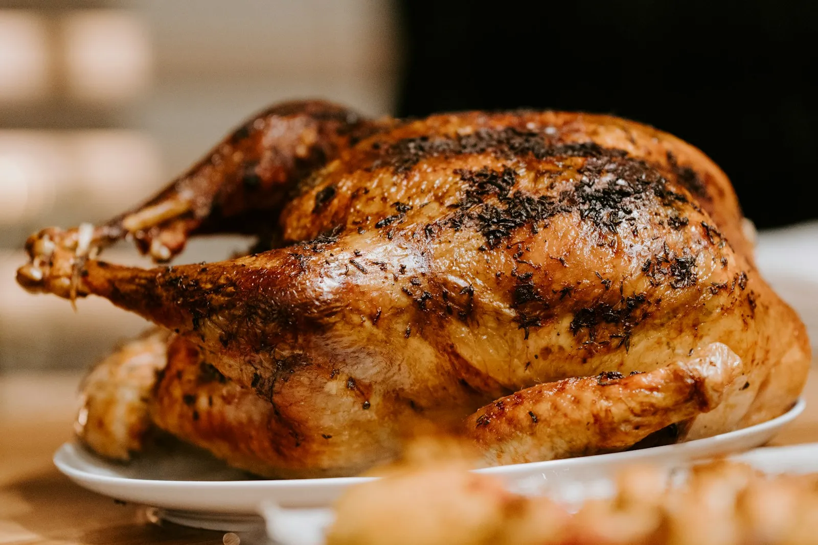 A golden roast chicken on a white plate